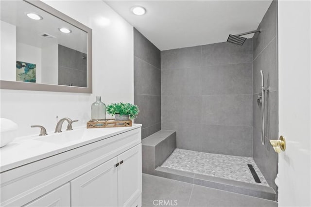 bathroom featuring vanity and tiled shower