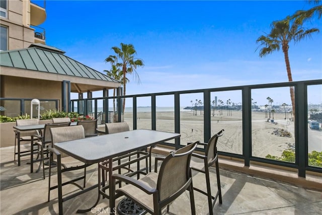 balcony with a patio area and a water view