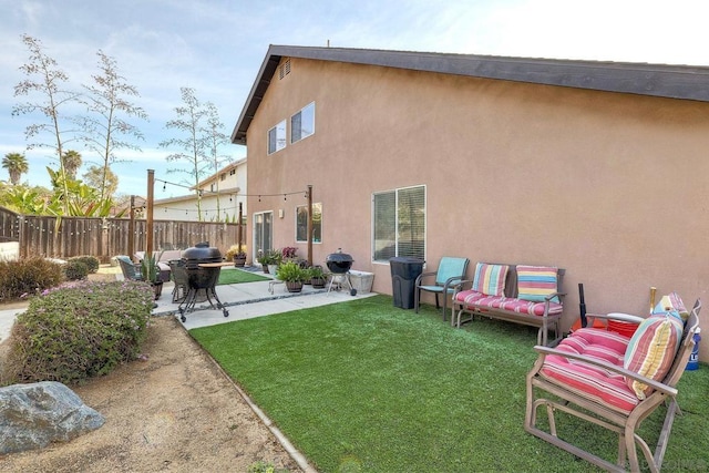 rear view of house featuring a yard and a patio