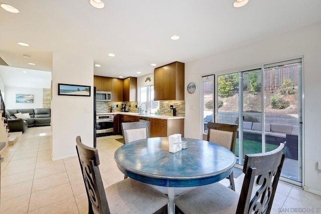 dining area with light tile patterned flooring and sink