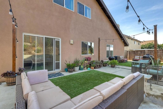 rear view of house with an outdoor living space, a yard, and a patio