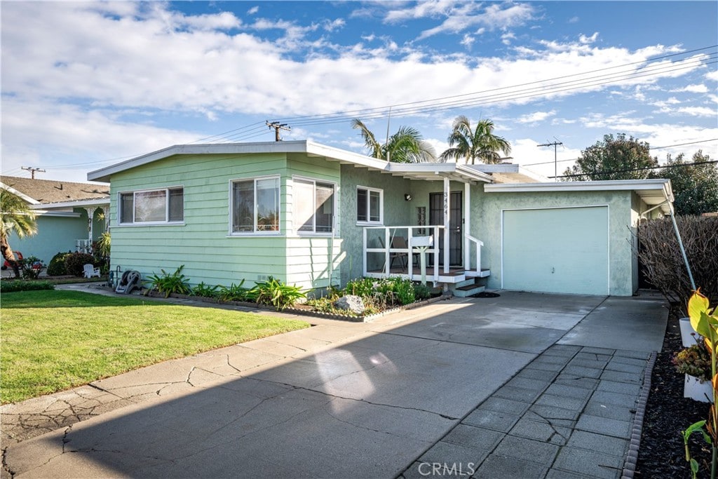 ranch-style home with a garage and a front yard