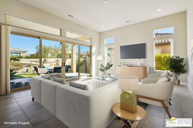 tiled living room with plenty of natural light