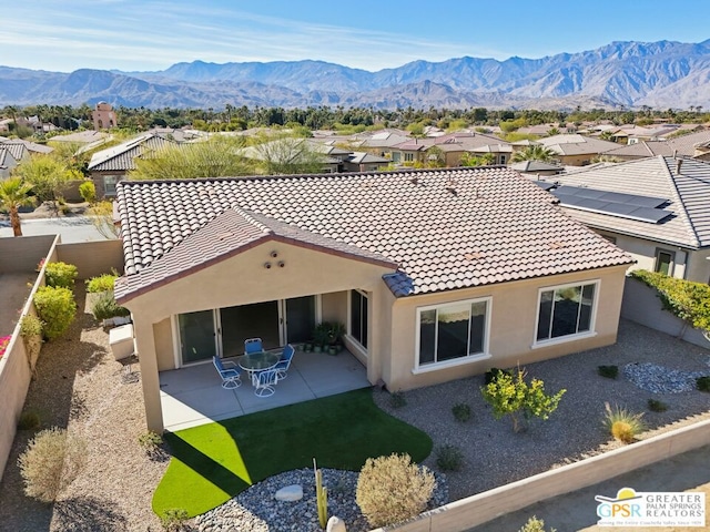 rear view of property featuring a patio and a mountain view