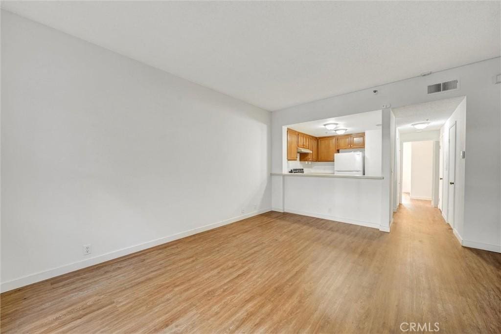 unfurnished living room with light hardwood / wood-style floors