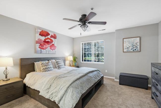 bedroom with light carpet and ceiling fan