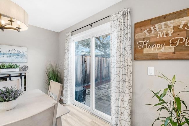 dining area with hardwood / wood-style flooring and an inviting chandelier