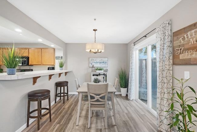 dining space featuring a chandelier and hardwood / wood-style floors