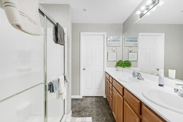 bathroom featuring walk in shower and vanity