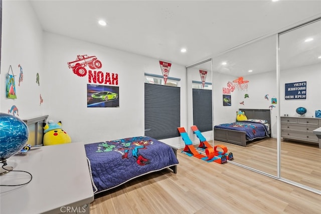 bedroom with hardwood / wood-style floors and a closet