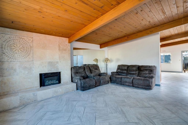 living room with beamed ceiling, light parquet flooring, a tiled fireplace, and wooden ceiling