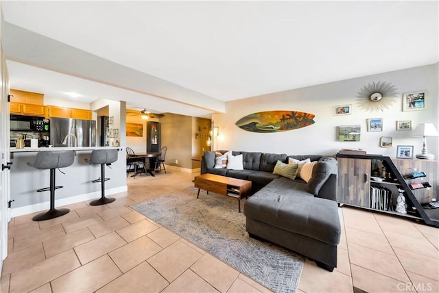 tiled living room with ceiling fan