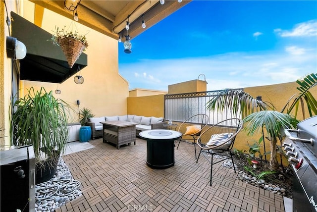 view of patio / terrace featuring an outdoor living space with a fire pit and grilling area