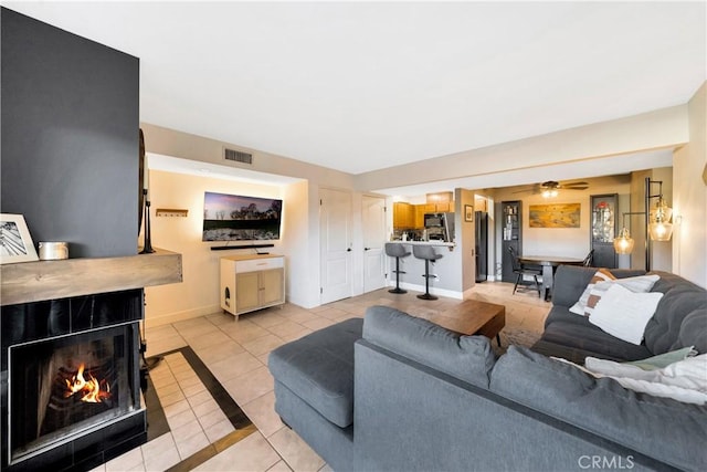 tiled living room with ceiling fan