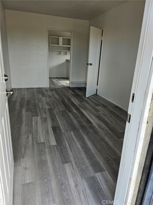 spare room featuring dark wood-type flooring