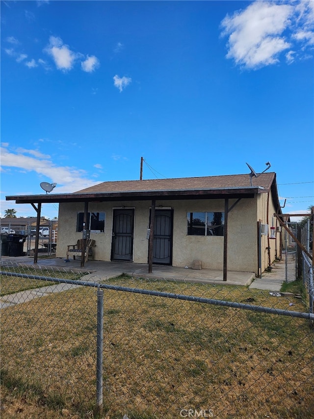 back of property featuring a yard