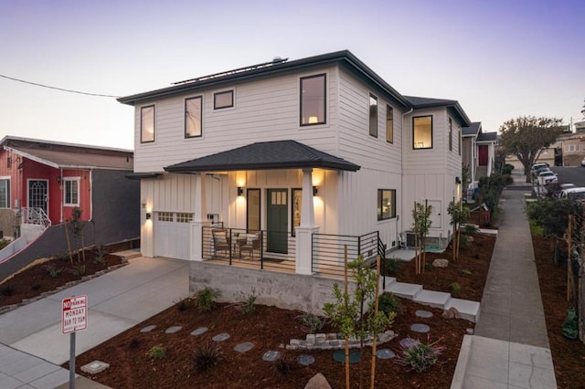 view of front of property featuring a porch and a garage