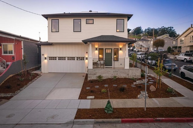 front facade featuring a garage and covered porch