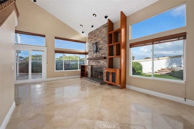 unfurnished living room featuring a fireplace and high vaulted ceiling