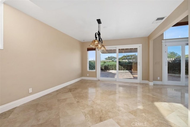 unfurnished dining area with plenty of natural light