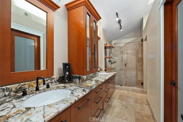 bathroom with an enclosed shower, vanity, and lofted ceiling