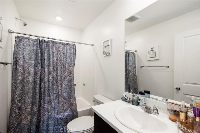 full bathroom featuring shower / tub combo with curtain, vanity, and toilet