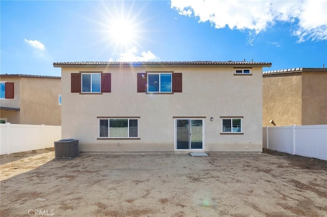 rear view of property featuring central AC unit