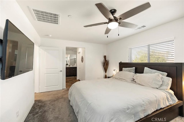 bedroom featuring ensuite bathroom, carpet floors, and ceiling fan