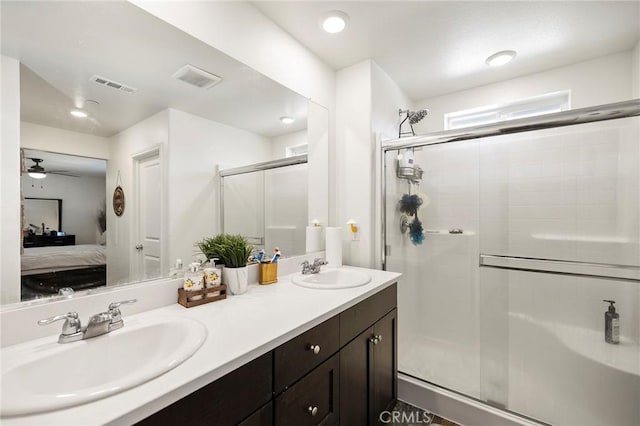 bathroom featuring vanity, a shower with door, and ceiling fan