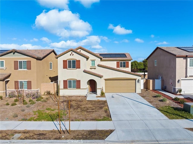 view of front of house featuring a garage and solar panels