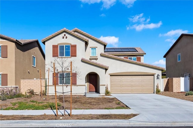 mediterranean / spanish home featuring a garage and solar panels