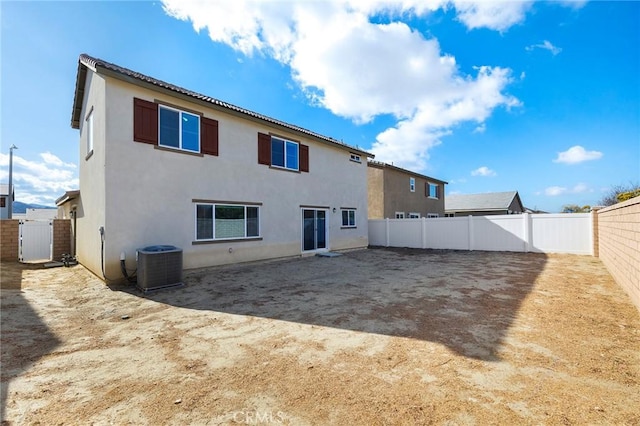 rear view of property featuring central AC unit