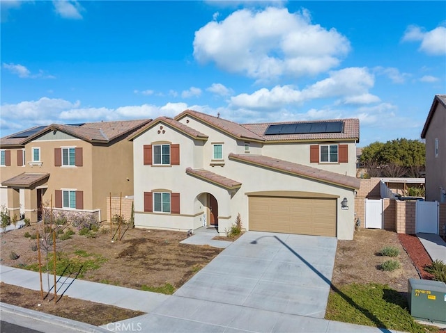 view of front of home with a garage and solar panels