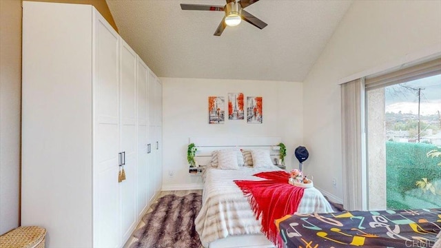 bedroom with ceiling fan, vaulted ceiling, and a closet