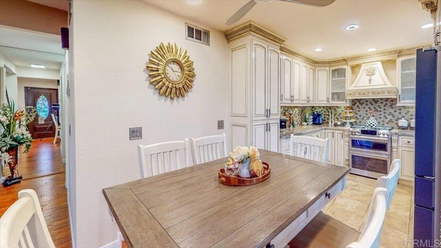 dining room with light tile patterned floors and ceiling fan