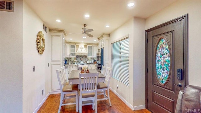 dining room with hardwood / wood-style flooring and ceiling fan