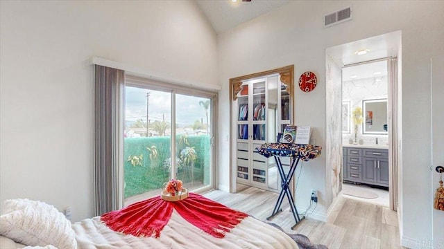 bedroom featuring ensuite bathroom and light wood-type flooring