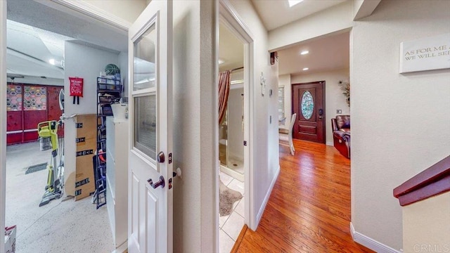 corridor with hardwood / wood-style flooring