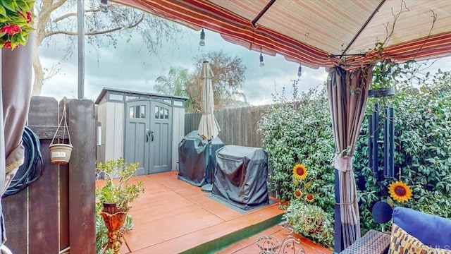 view of patio / terrace with a gazebo, grilling area, and a storage unit