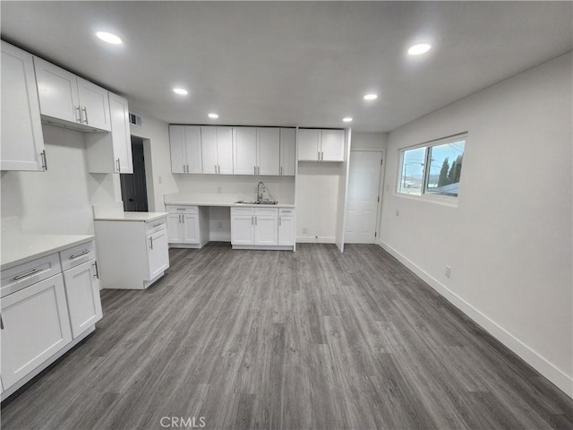 kitchen featuring white cabinetry, hardwood / wood-style floors, and sink