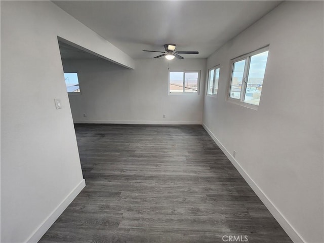 unfurnished room with dark wood-type flooring and ceiling fan