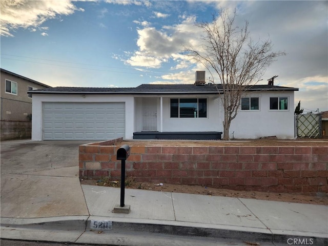 single story home featuring a garage and central air condition unit