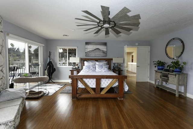 bedroom featuring dark hardwood / wood-style flooring and access to outside