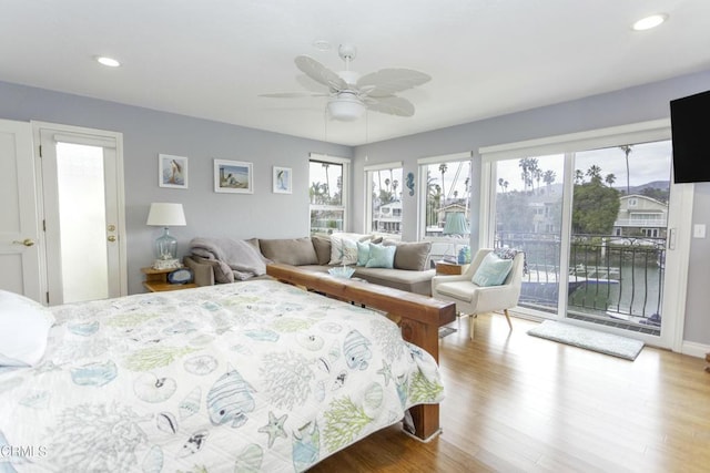 bedroom with ceiling fan, hardwood / wood-style floors, and access to outside