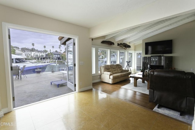 living room with lofted ceiling with beams