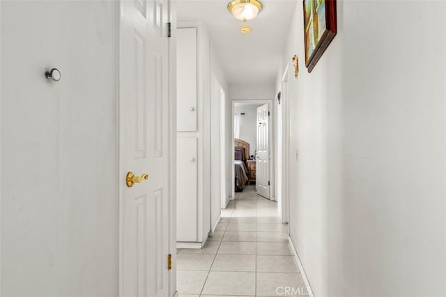 corridor featuring light tile patterned floors