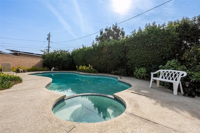 view of swimming pool with an in ground hot tub and a patio