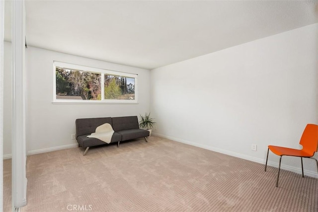 living area featuring light colored carpet