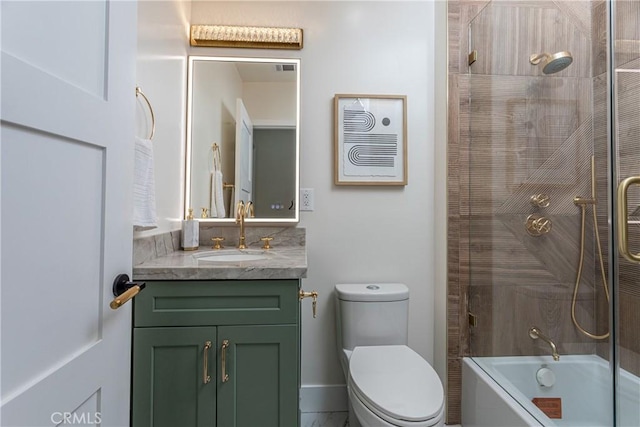 full bathroom with tiled shower / bath, vanity, and toilet