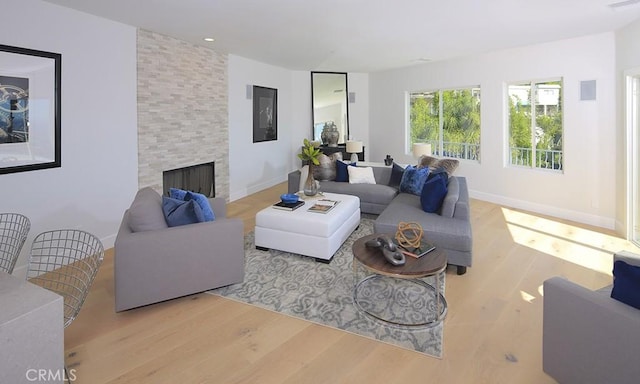 living room featuring a fireplace and light hardwood / wood-style floors